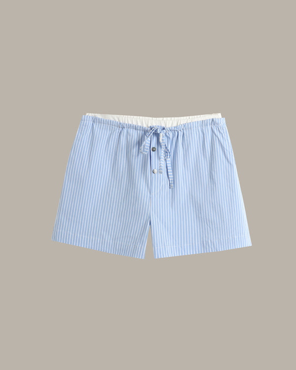 Light blue and white vertically striped drawstring shorts with a button fly, shown flat against a solid taupe background.