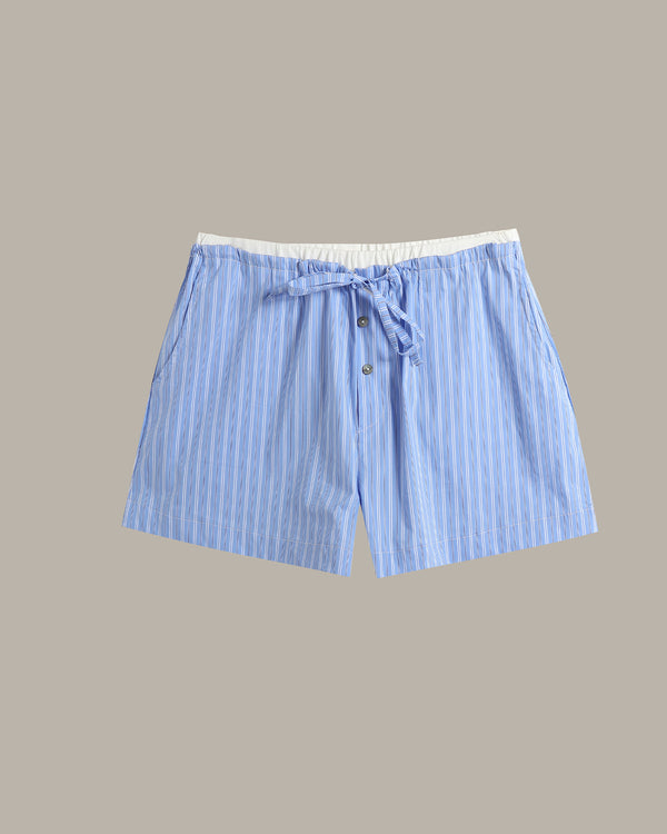 Light blue and white vertically striped drawstring shorts with a white elastic waistband, shown flat against a solid taupe background.