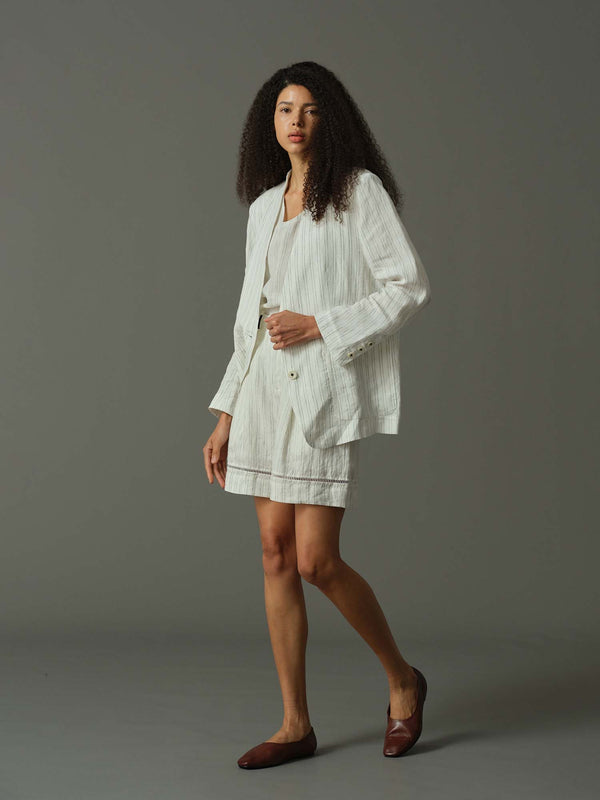 Woman wearing a white outfit on a gray background