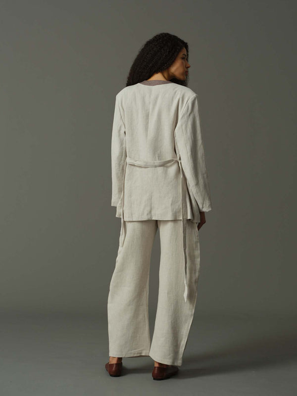 back of a model wearing light grey suit 