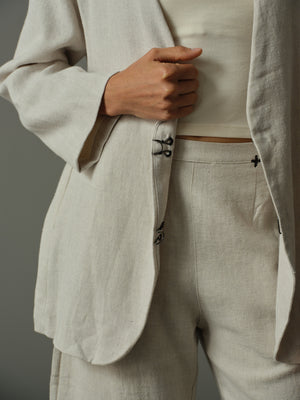 Beige suit jacket and pants with a neutral background
