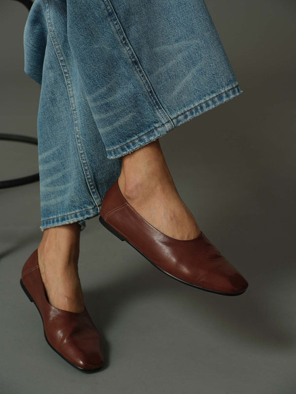 close up of model wearing a pair of brown leather flats