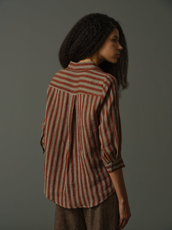 Woman wearing a red and white striped shirt against a gray background