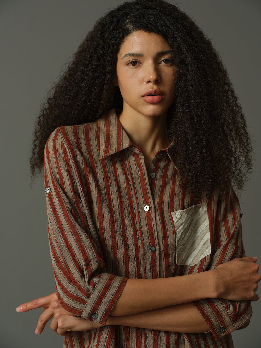 Red and white striped shirt with a pocket on a beige background