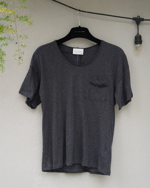 Gray t-shirt on a hanger against a light background