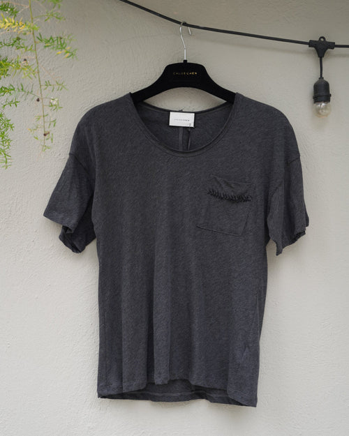 Gray t-shirt on a hanger against a light background