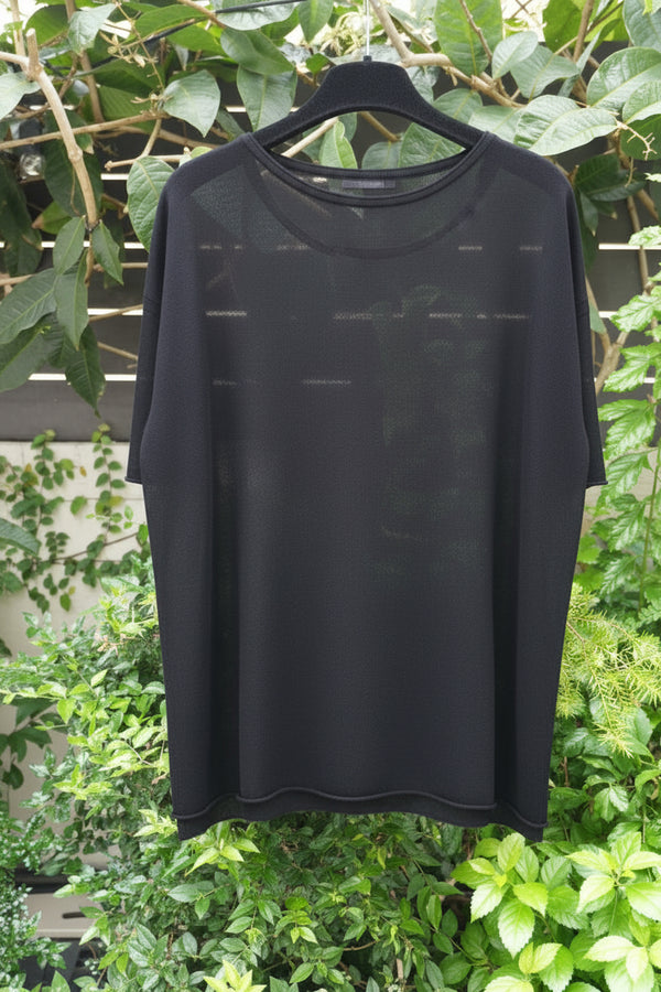 back of a black top hanging on the tree 