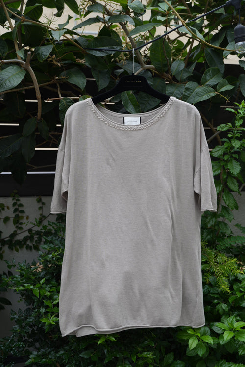  a grey top hanging on the tree 