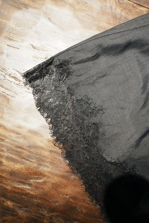 Close-up of a black fabric edge on a wooden surface