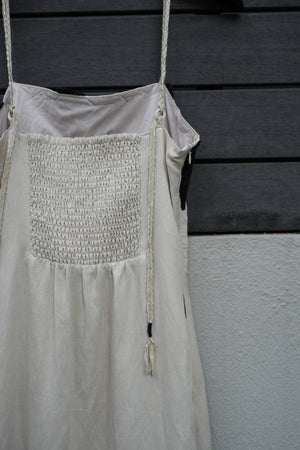 beige dress with decorative patch on a dark background
