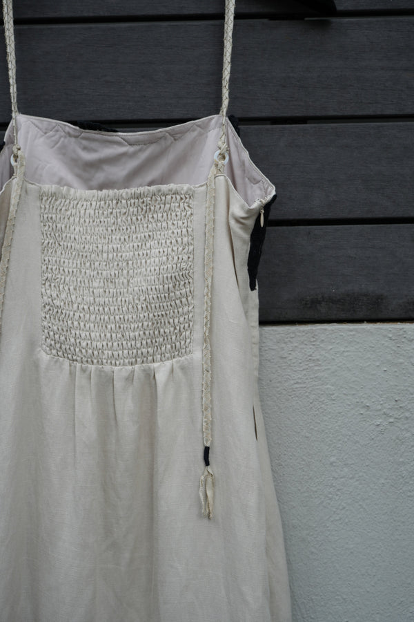 beige dress with decorative patch on a dark background