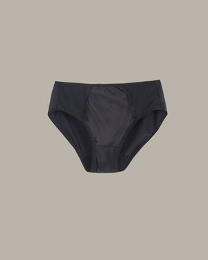 Black underwear on a beige background