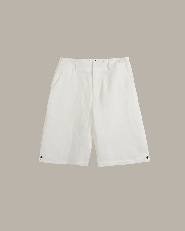 White shorts with a small black embroidered logo on each hem, displayed flat against a solid taupe background.