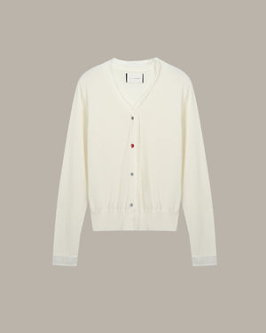 White cardigan on a beige background