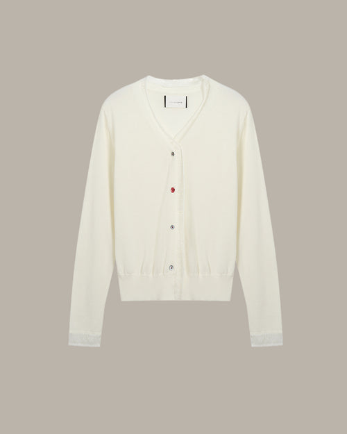 White cardigan on a beige background