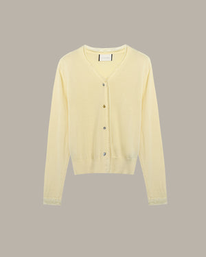 Light yellow cardigan on a beige background