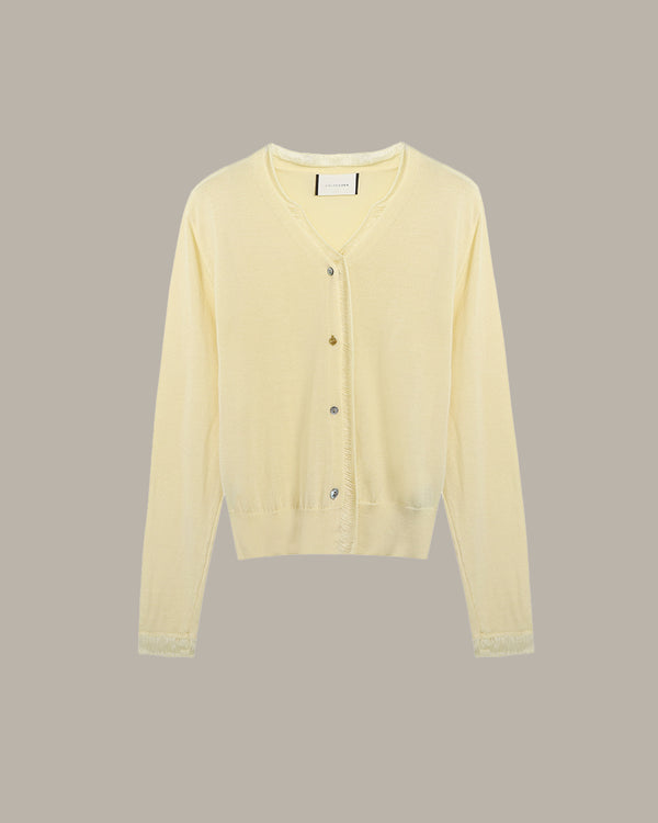 Light yellow cardigan on a beige background