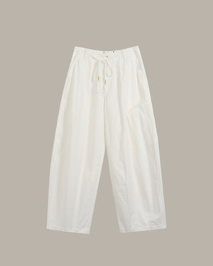 White pants on a beige background