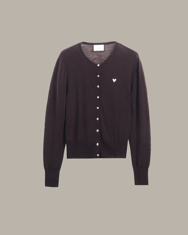 A dark brown button-up cardigan sweater with a small white embroidered heart on the left chest, displayed against a solid taupe background.