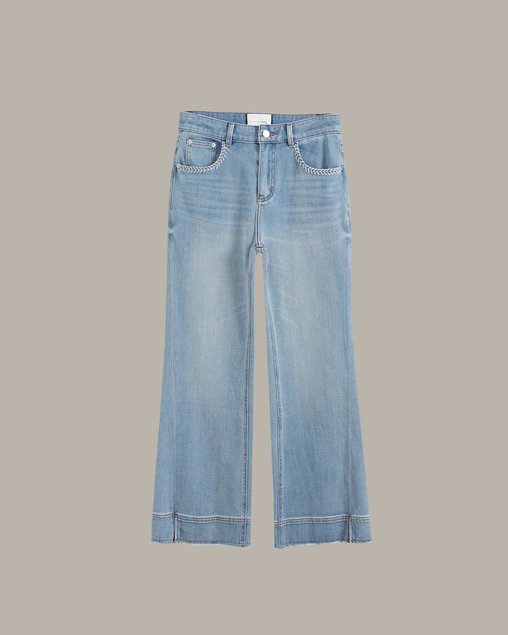 Light blue wide-leg denim jeans with decorative silver chain detailing along the pocket hems, shown flat against a solid taupe background.