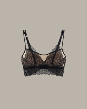 Black lace bra on a beige background