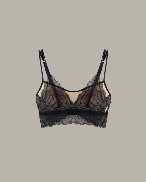 Black lace bra on a beige background