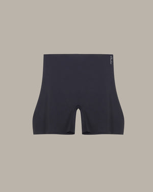 Black athletic shorts on a beige background