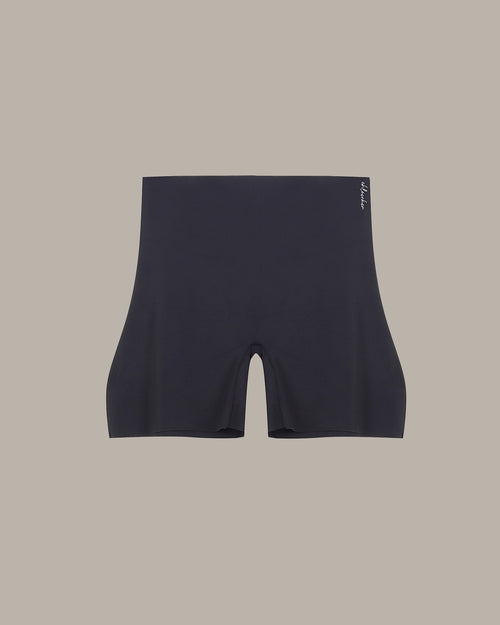 Black athletic shorts on a beige background