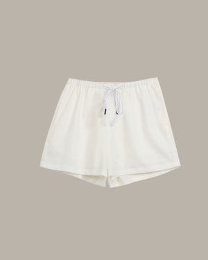White shorts with a drawstring on a beige background