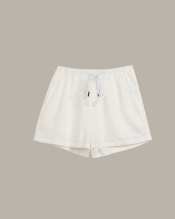 White shorts with a drawstring on a beige background