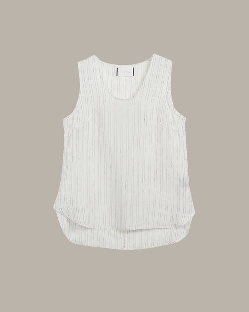 White sleeveless top with thin black stripes on a beige background
