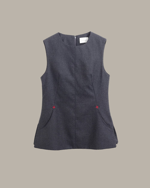 A sleeveless dark gray textured vest with a round neckline, front pockets, and small red embroidered star details on the sides, shown against a solid beige background.