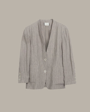 Gray blazer with button details on a beige background