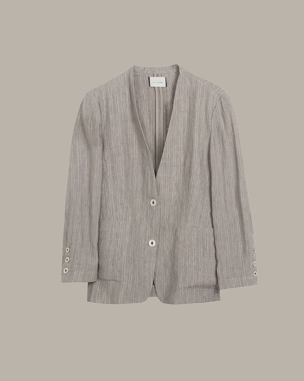 Gray blazer with button details on a beige background