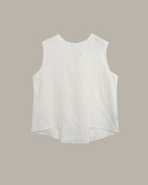 A sleeveless white high-low top with a round neckline, laid flat against a solid taupe background.