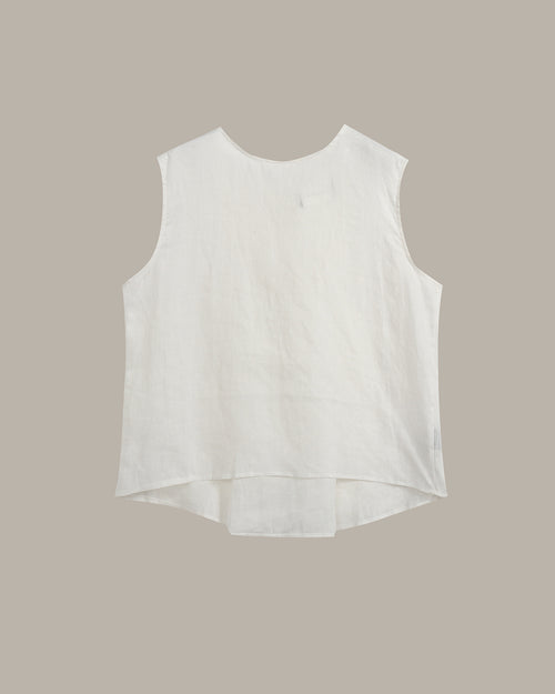 A sleeveless white high-low top with a round neckline, laid flat against a solid taupe background.