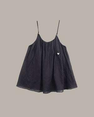 Black cami  with a heart detail on a beige background