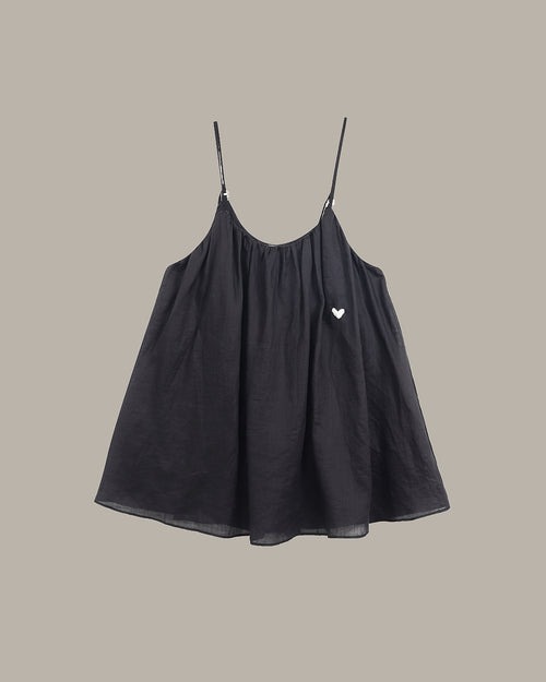 Black cami  with a heart detail on a beige background