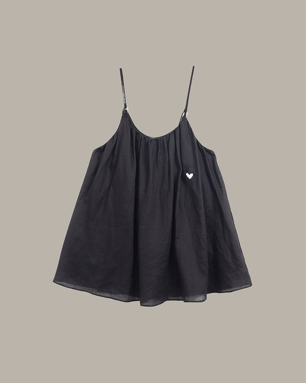 Black cami  with a heart detail on a beige background