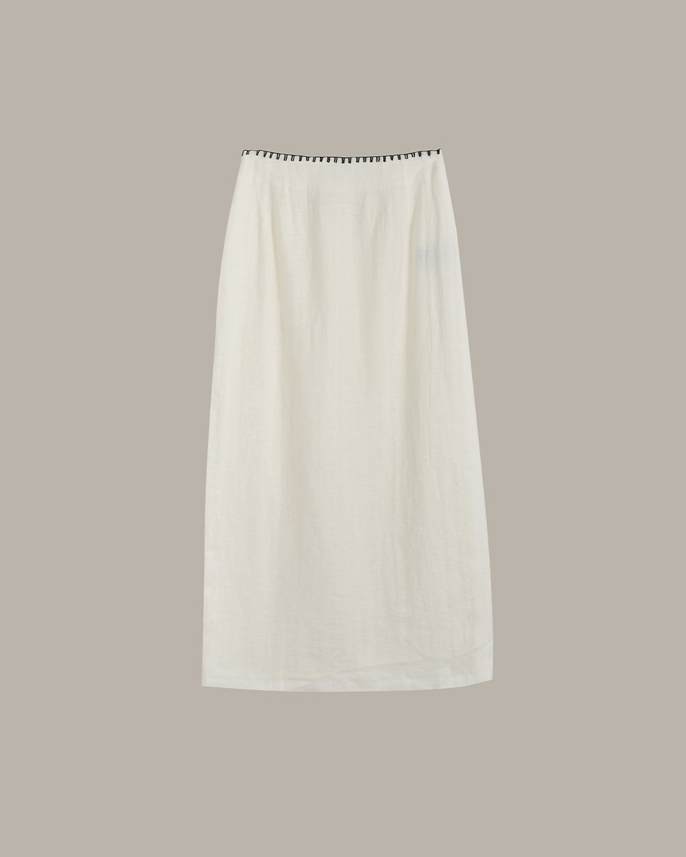 White skirt with black trim on a beige background