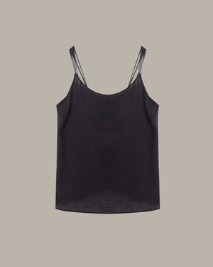 Black tank top with lace trim on straps against a beige background