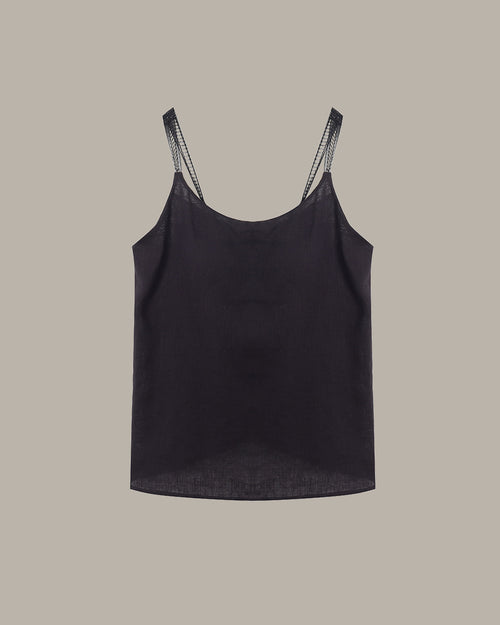 Black tank top with lace trim on straps against a beige background