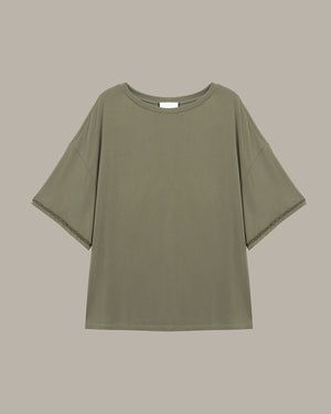 Green t-shirt on a beige background