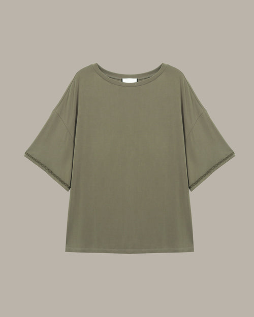 Green t-shirt on a beige background