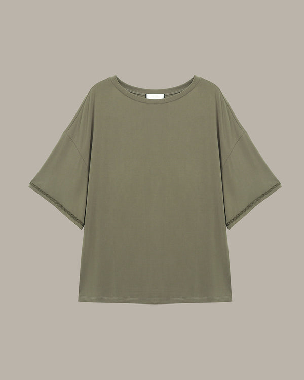 Green t-shirt on a beige background