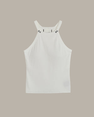 White halter neck tank top with black stitch on a beige background