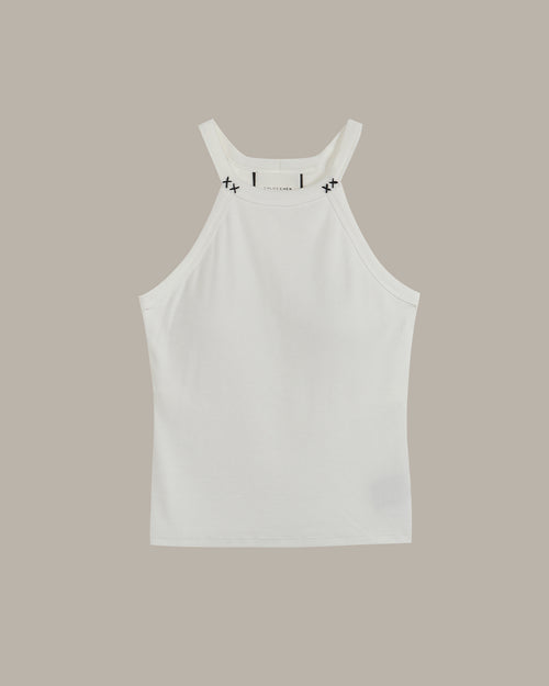 White halter neck tank top with black stitch on a beige background