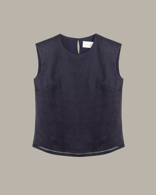 Dark blue sleeveless top on a beige background