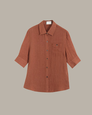 Brown button-up shirt on a beige background