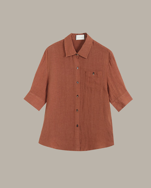 Brown button-up shirt on a beige background